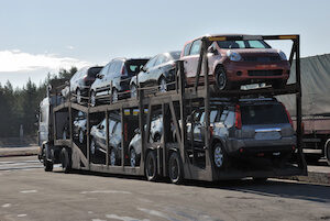 Truck shipping cars on freeway.