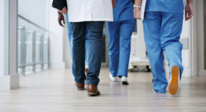 Healthcare workers walking down hall