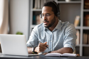 Man using computer and headphones