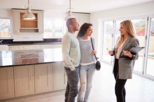 Female realtor showing a house to a couple