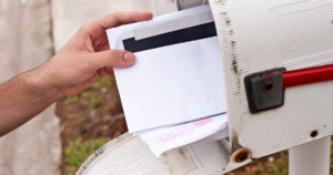 Person reaching into a mailbox